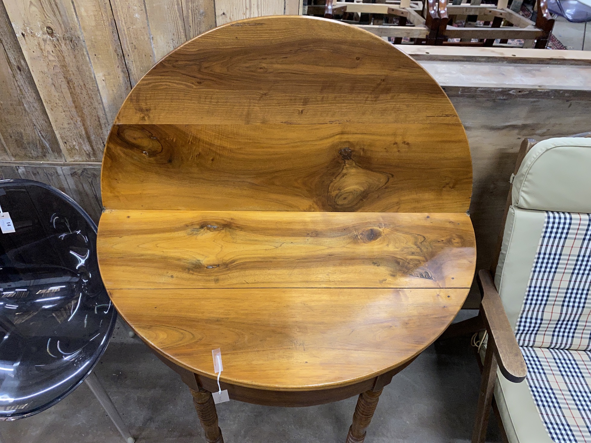 A 19th century French cherry 'D' shaped folding tea table, width 111cm, depth 55cm, height 79cm